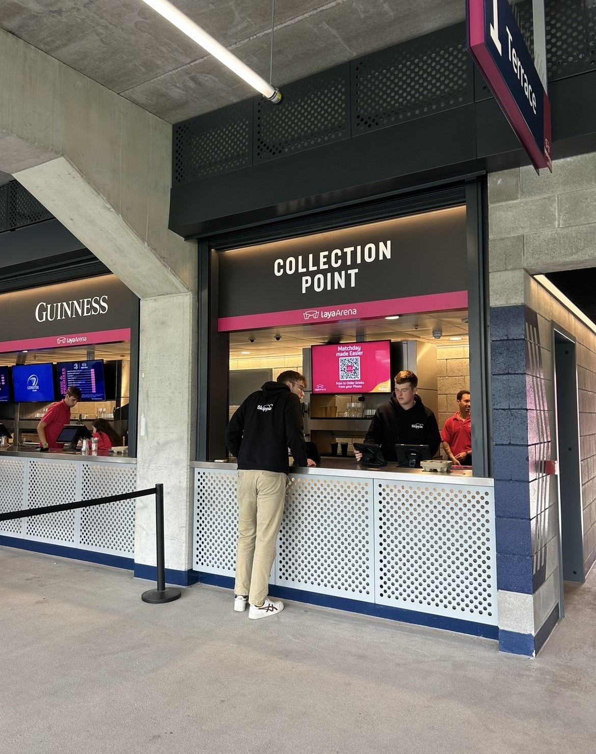 A fan collecting a drinks order at a Skippio collection point at Laya Arena, with no queue