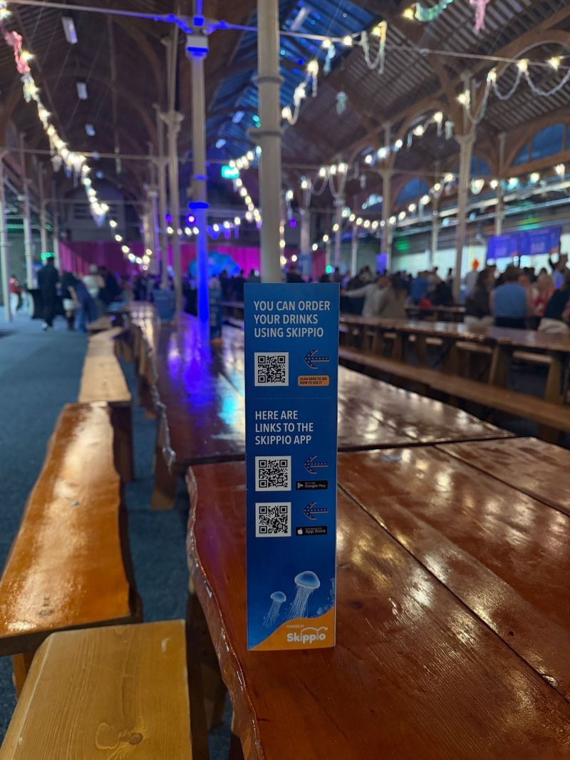 Skippio table talker with QR codes to order drinks and download the app at a private event